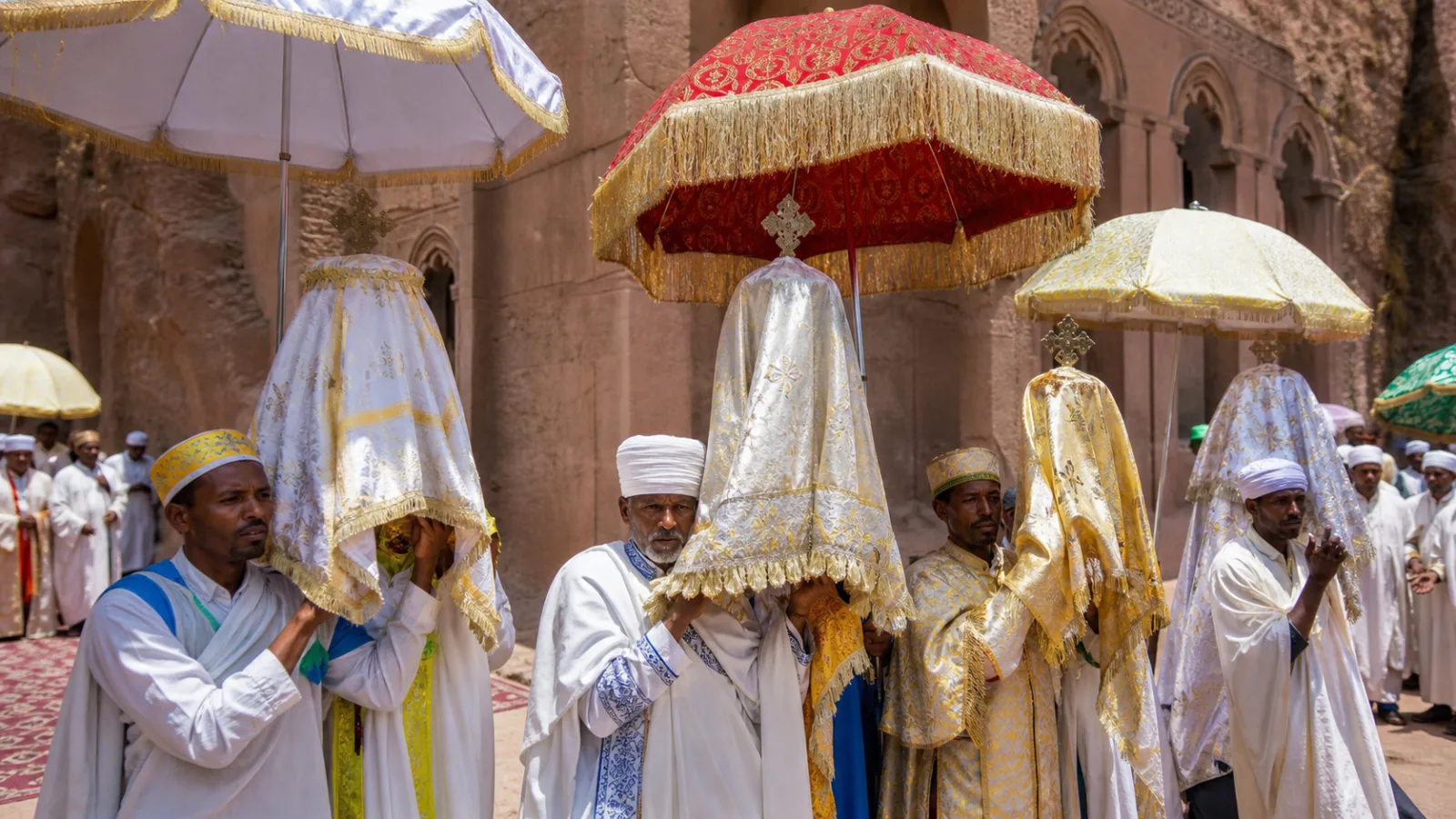 Ethiopian Orthodox procession with priests carrying wrapped ceremonial tabot tablets under decorated umbrellas
