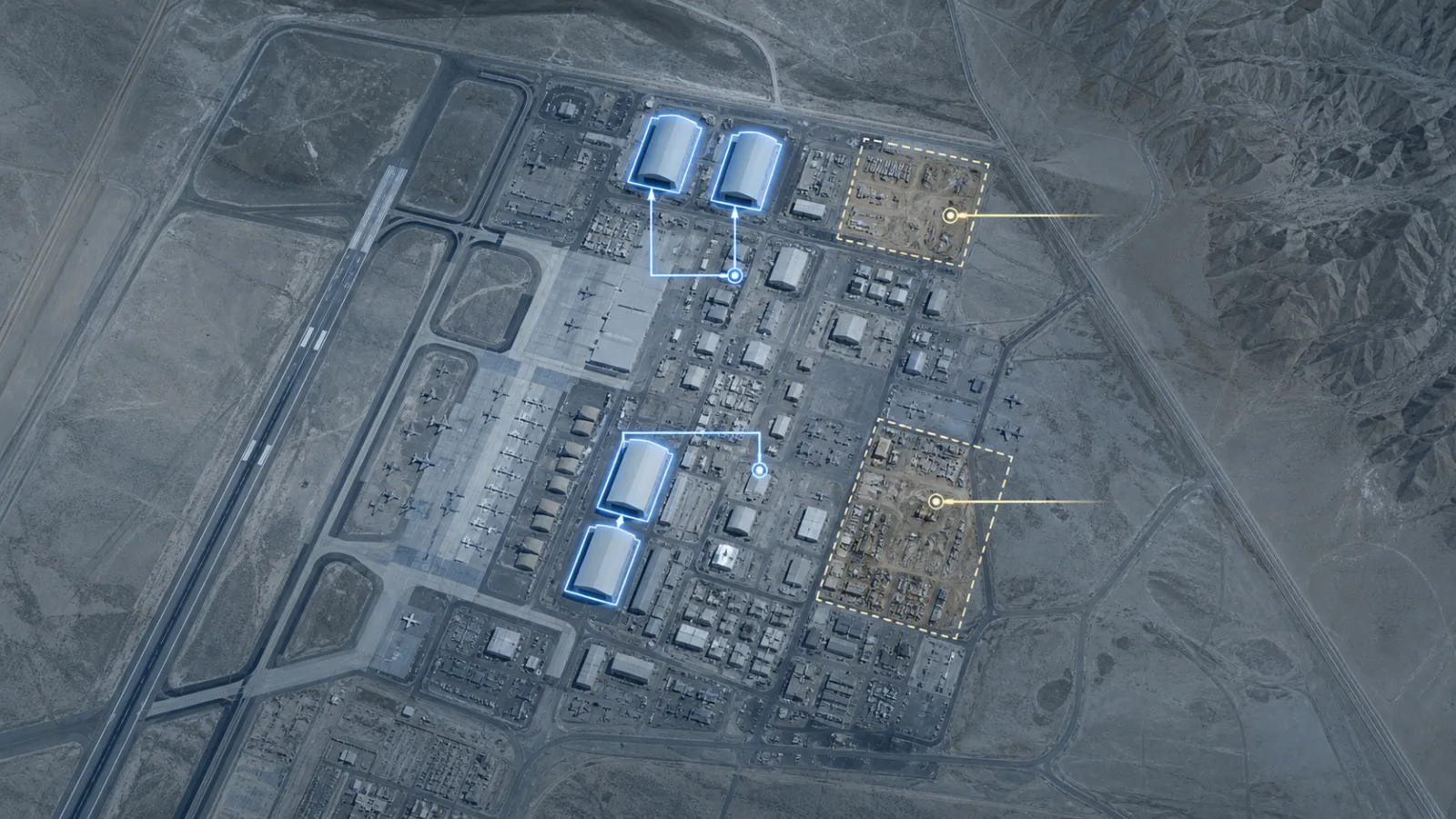 Simulated satellite map view of a desert airbase showing new hangar structures and construction markers