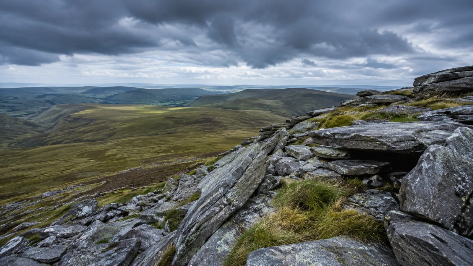 Rugged green Preseli Hills in Wales with rocky bluestone outcrops under an overcast sky
